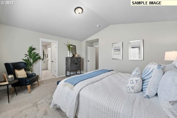 bedroom featuring light colored carpet and vaulted ceiling