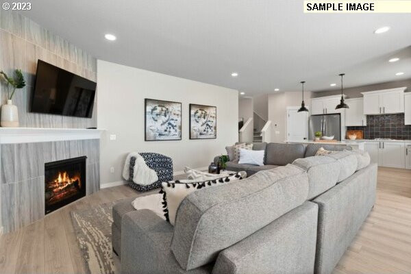 living room with a fireplace and light hardwood / wood-style floors