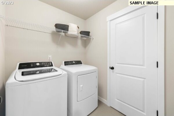 washroom featuring washing machine and clothes dryer