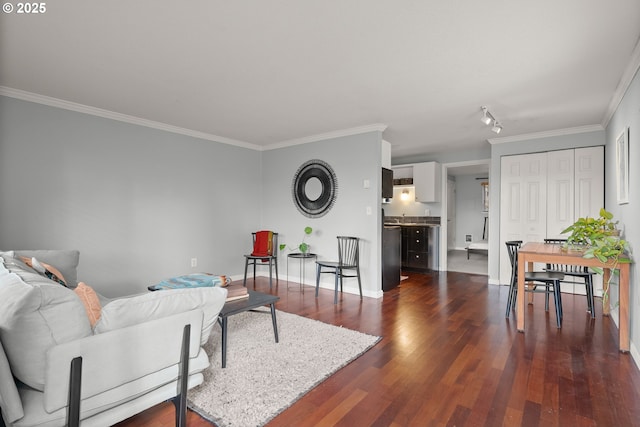 living area with baseboards, dark wood finished floors, and crown molding