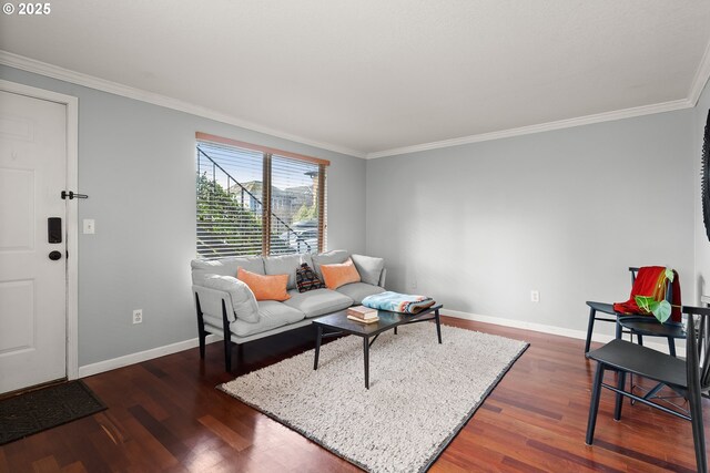 living room featuring dark hardwood / wood-style flooring, a textured ceiling, and ornamental molding