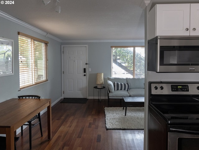 interior space featuring white cabinets, appliances with stainless steel finishes, plenty of natural light, and dark wood-type flooring