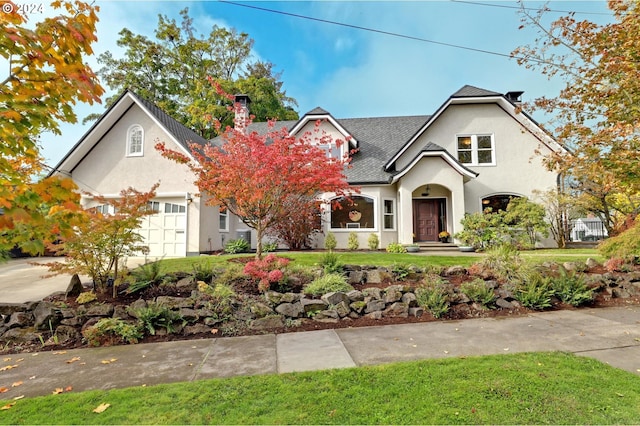 view of front of property featuring a front yard and a garage