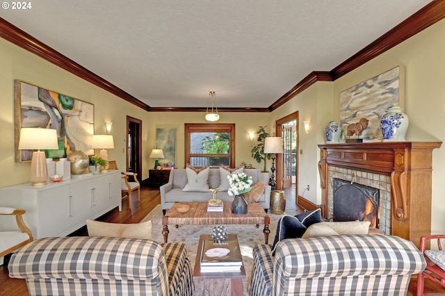 living room featuring ornamental molding, a fireplace, and wood-type flooring