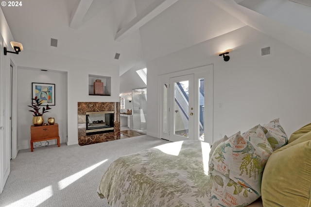 bedroom with carpet flooring, access to outside, beamed ceiling, high vaulted ceiling, and a premium fireplace