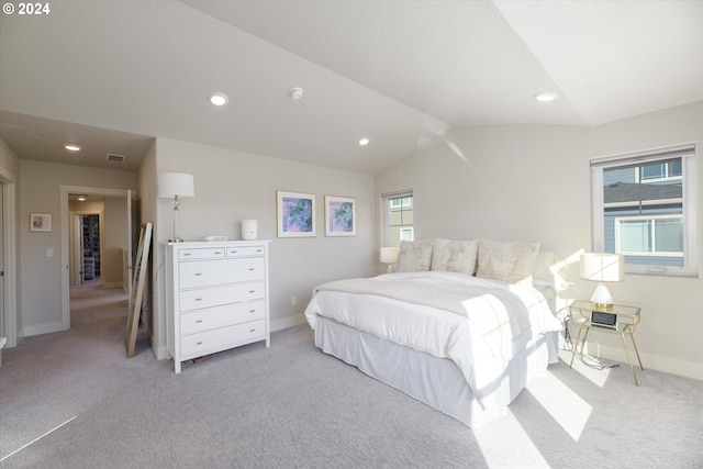 carpeted bedroom with lofted ceiling