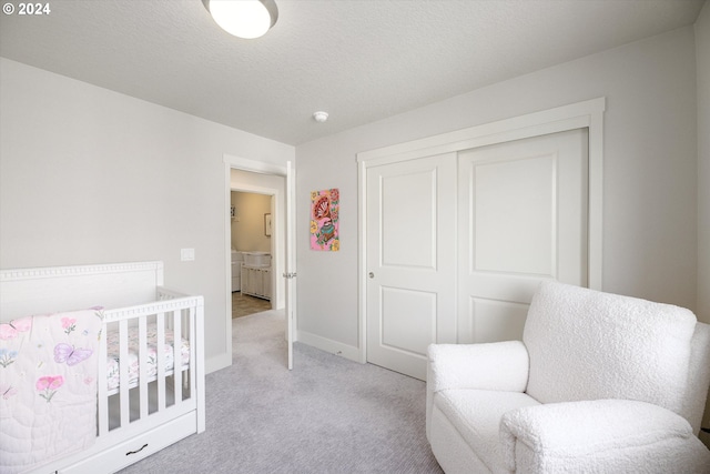 carpeted bedroom featuring a closet and a textured ceiling