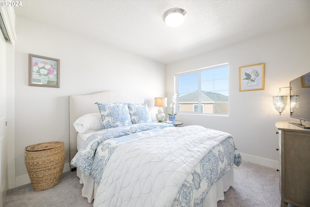 carpeted bedroom featuring a textured ceiling