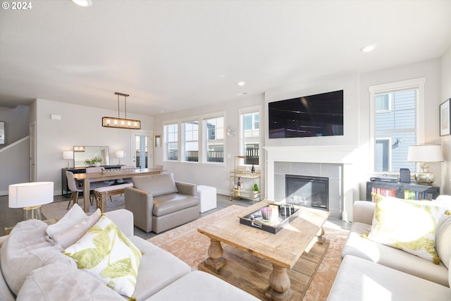 living room featuring light wood-type flooring and a fireplace