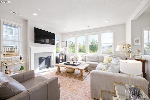 living room featuring a fireplace and a textured ceiling