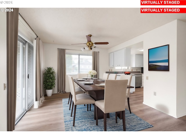 dining area with ceiling fan and light hardwood / wood-style floors