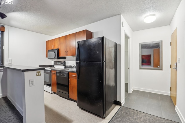 kitchen with black appliances, sink, and a textured ceiling