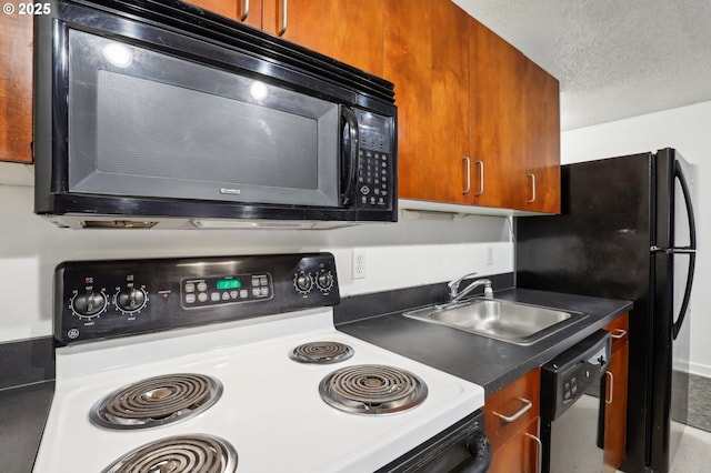 kitchen featuring black appliances, sink, and a textured ceiling