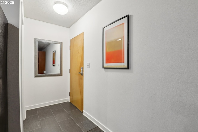 hallway featuring a textured ceiling