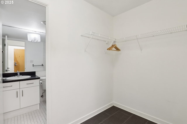 spacious closet with tile patterned flooring and sink