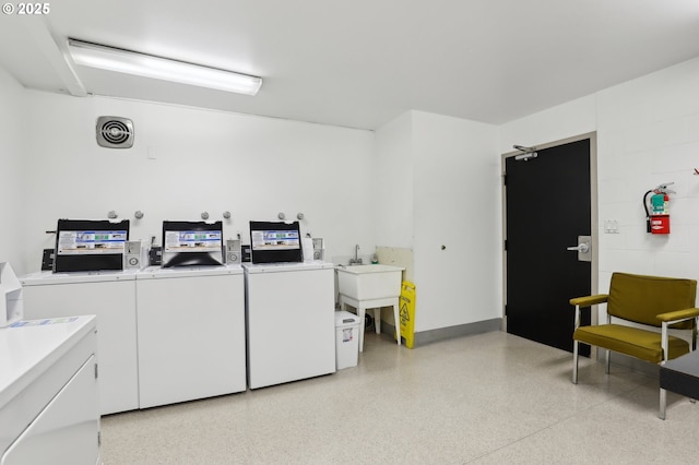 clothes washing area featuring independent washer and dryer