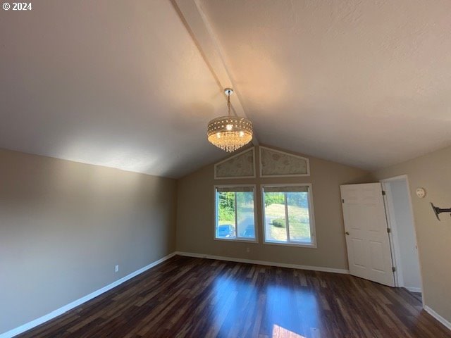 interior space featuring lofted ceiling, dark hardwood / wood-style flooring, and a notable chandelier