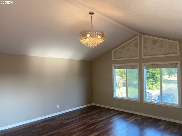 interior space with a textured ceiling, vaulted ceiling, dark hardwood / wood-style floors, and a notable chandelier