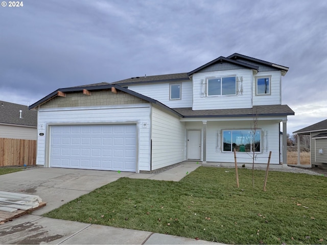 view of front facade featuring a front lawn and a garage