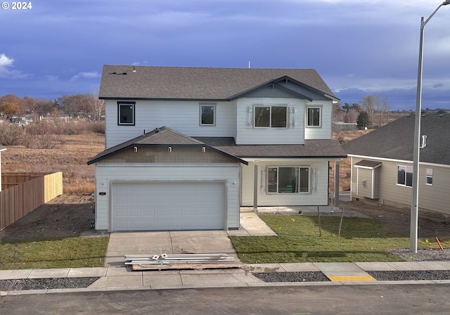 view of front property featuring a garage and a front lawn