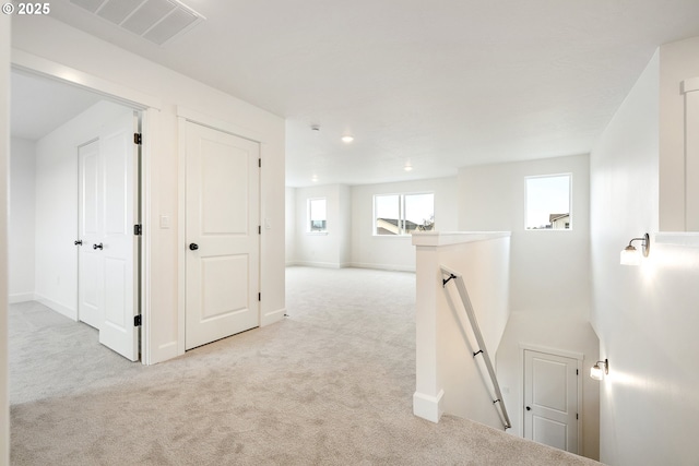 corridor with light colored carpet