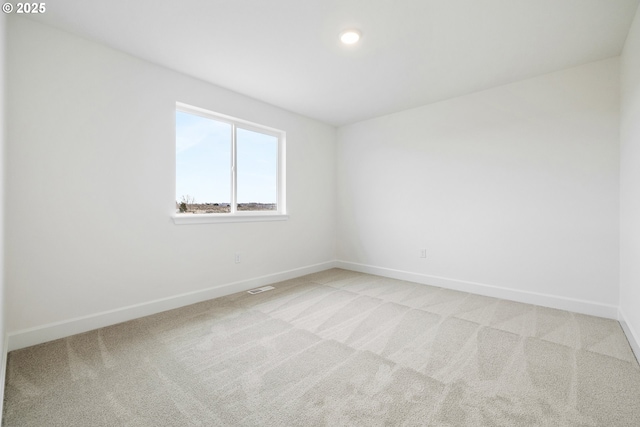 unfurnished room with light carpet