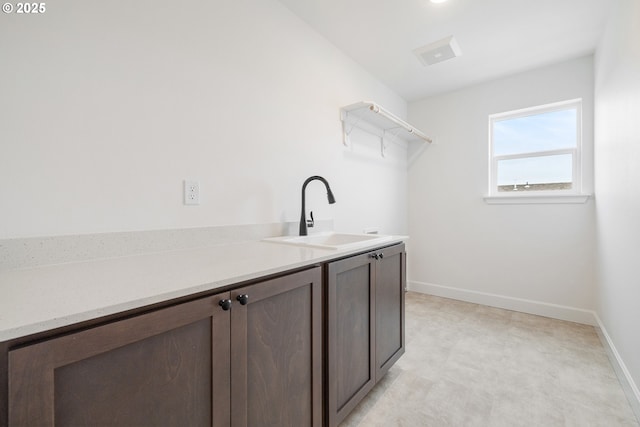 clothes washing area featuring sink