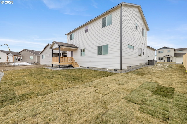 back of house featuring cooling unit, a yard, and a deck