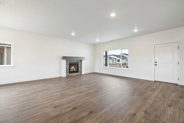 unfurnished living room with dark hardwood / wood-style floors and a fireplace