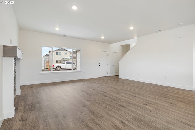 unfurnished living room with hardwood / wood-style floors