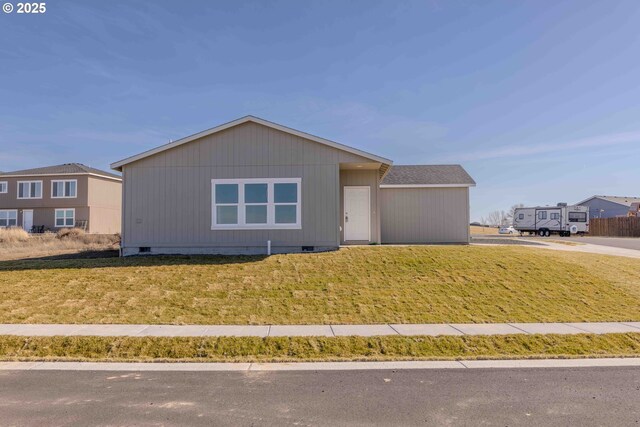 single story home with a garage and a front lawn