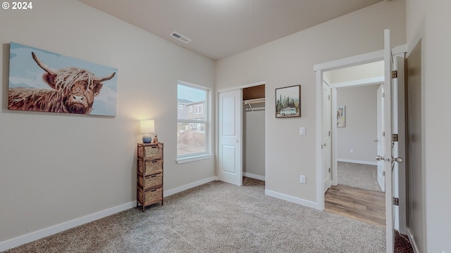 unfurnished bedroom with carpet floors, baseboards, visible vents, and a closet