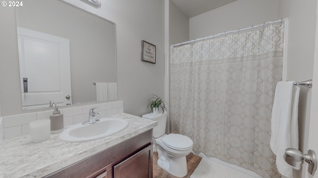 bathroom featuring curtained shower, vanity, and toilet