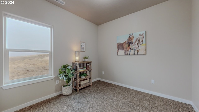 interior space featuring carpet flooring, visible vents, and baseboards