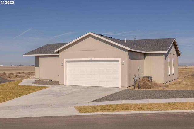 view of side of home featuring central AC and a garage