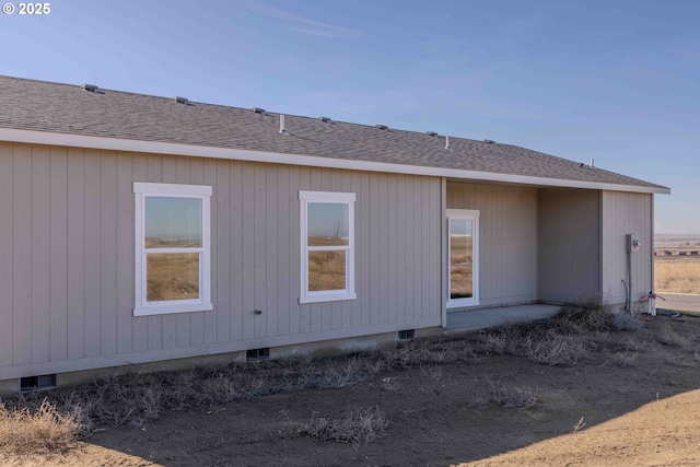 back of property featuring crawl space and roof with shingles