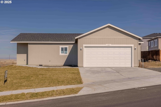 single story home featuring an attached garage, a shingled roof, a front lawn, and concrete driveway