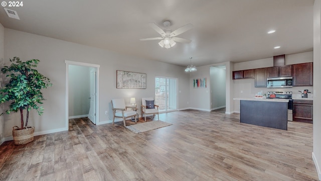 kitchen featuring stainless steel appliances, light countertops, light wood-style floors, and a ceiling fan