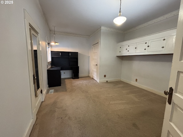 laundry area featuring light carpet and ornamental molding