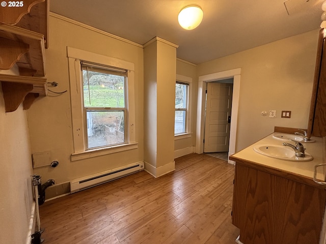 bathroom with wood-type flooring, vanity, and baseboard heating