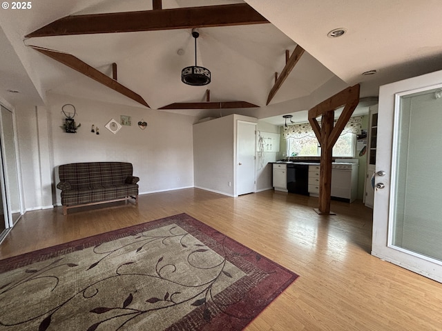 unfurnished living room featuring hardwood / wood-style floors and vaulted ceiling with beams