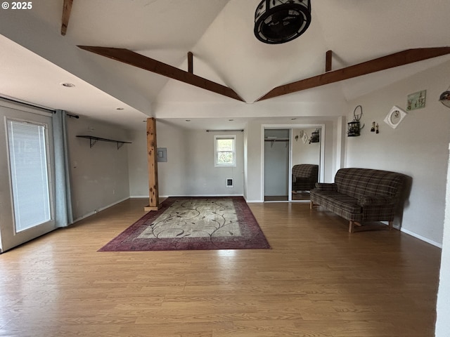 foyer entrance featuring vaulted ceiling with beams and light hardwood / wood-style floors