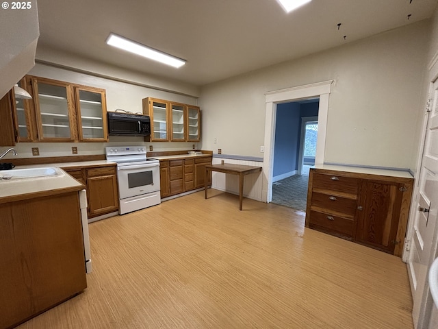 kitchen featuring white electric range oven and sink