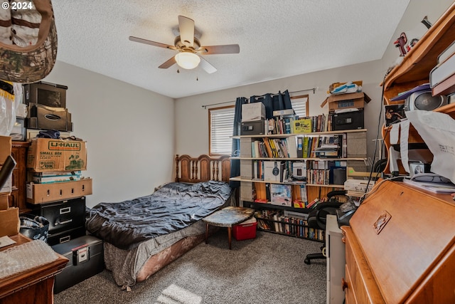 bedroom with a textured ceiling, carpet flooring, and ceiling fan