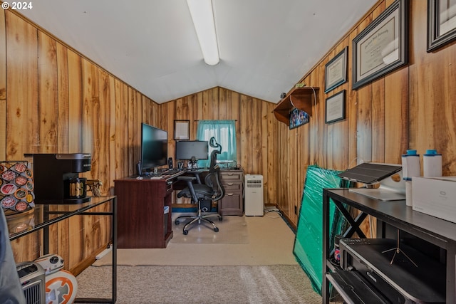 carpeted home office featuring lofted ceiling and wooden walls