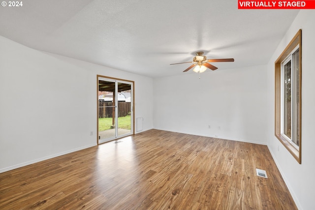 spare room featuring ceiling fan, a textured ceiling, and hardwood / wood-style floors