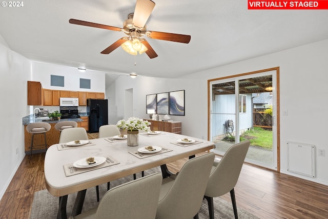 dining space with sink, ceiling fan, and dark hardwood / wood-style flooring