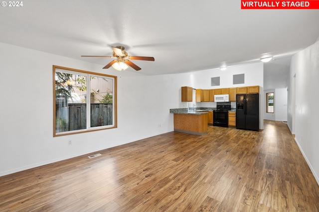 kitchen featuring dark hardwood / wood-style floors, kitchen peninsula, sink, black appliances, and ceiling fan