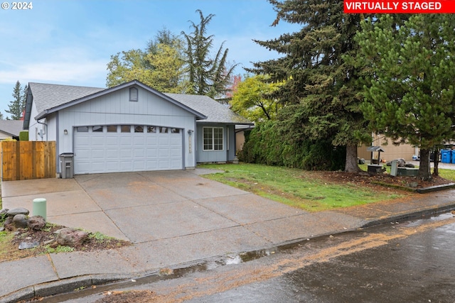 view of front of property featuring a front lawn and a garage