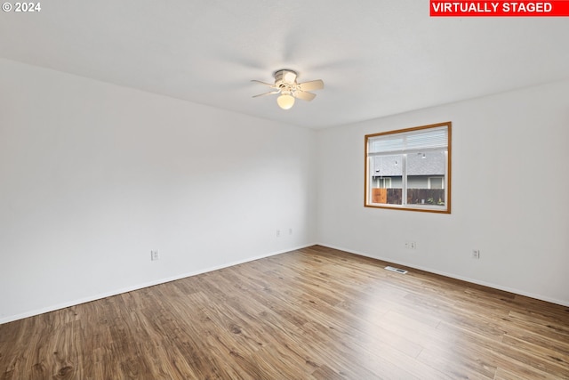 empty room featuring hardwood / wood-style flooring and ceiling fan